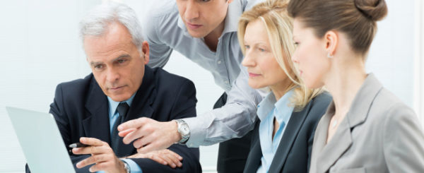 Team Of Business People Working Together On A Laptop